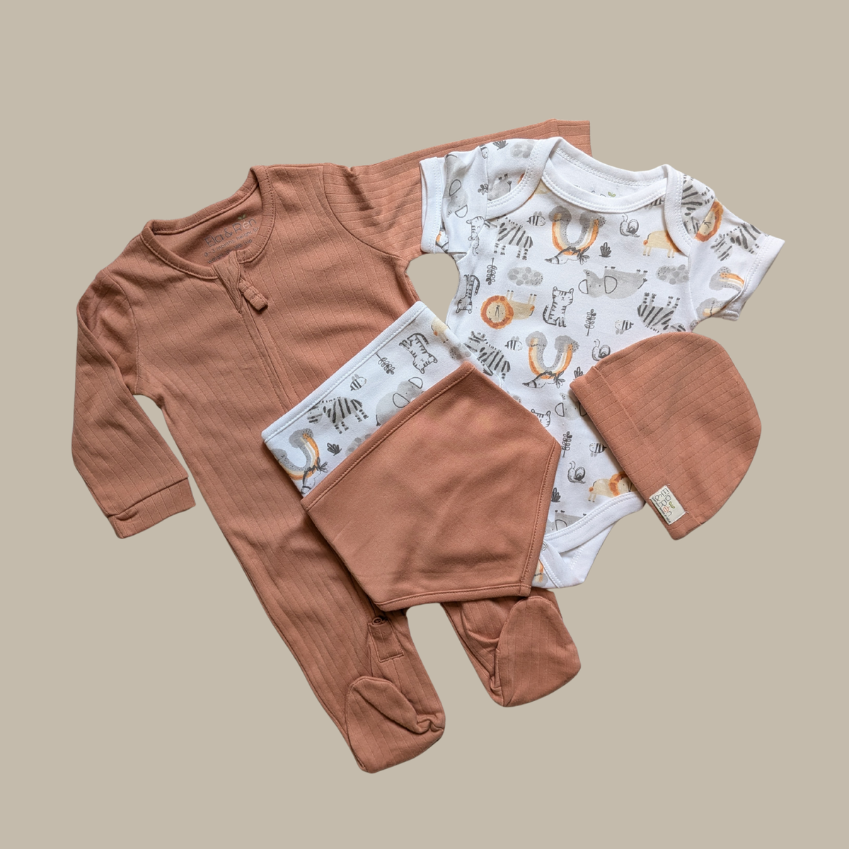 A baby clothing set including a long-sleeve footed romper in terracotta, a short-sleeve bodysuit with a white background and animal print, matching bibs, and a terracotta hat.