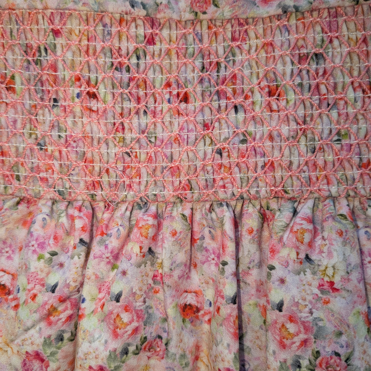 Floral fabric with smocked top and ruffled bottom