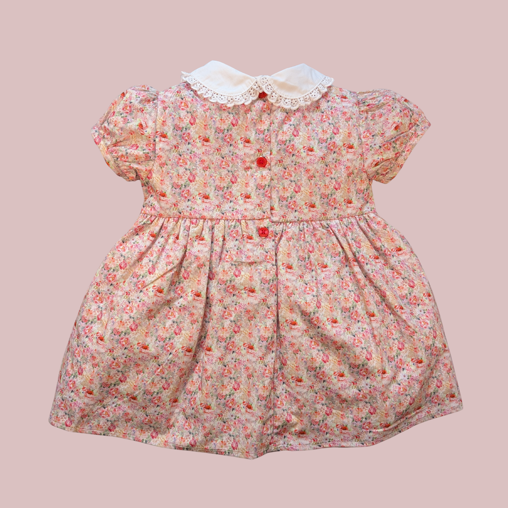 Floral dress with a white collar on a pink background