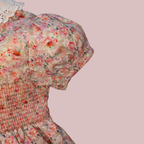 Floral dress with a textured pattern on a pink background