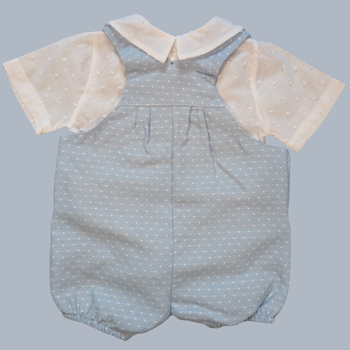 Baby romper with beige collar and sleeves on a gray background