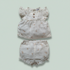 Baby set - top and shorts on a light green background