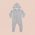 A light grey baby hooded all-in-one with a front zipper, long sleeves, and cuffed legs