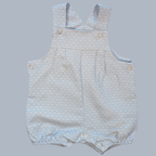 Baby romper with light blue polka dot pattern on a gray background