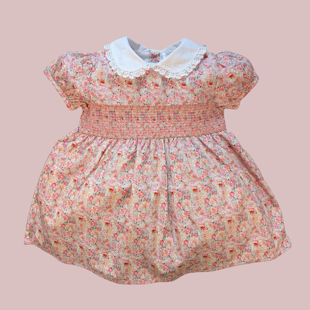 Floral dress with a white collar on a pink background