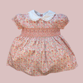 Floral dress with a white collar on a pink background