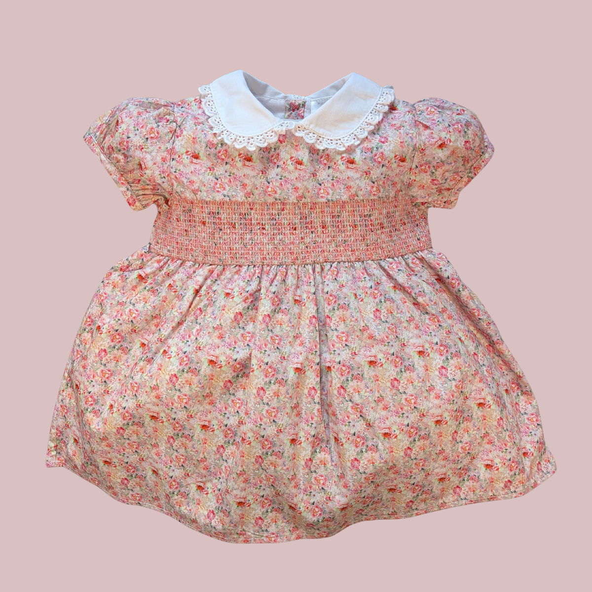 Floral dress with a white collar on a pink background