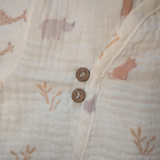 Close-up of a fabric with animal prints and buttons on a beige background